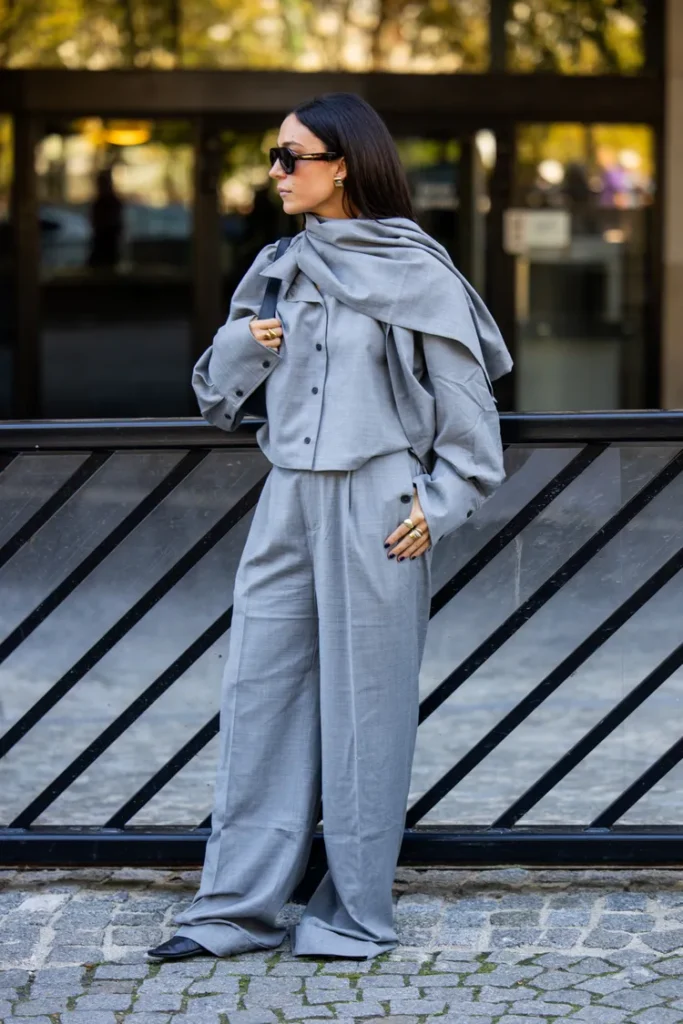 “Model wearing a scarf coat with built-in scarf detail, ideal for cold December weather.”