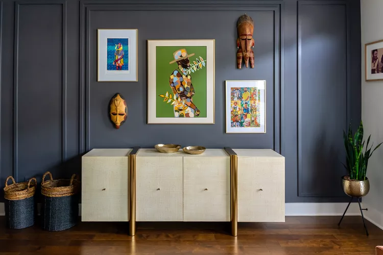 “Wooden wall paneling behind neutral modern living room furniture”